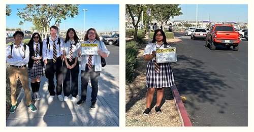 Mrs. Alba's science ethics students outside holding up SLOW DOWN signs